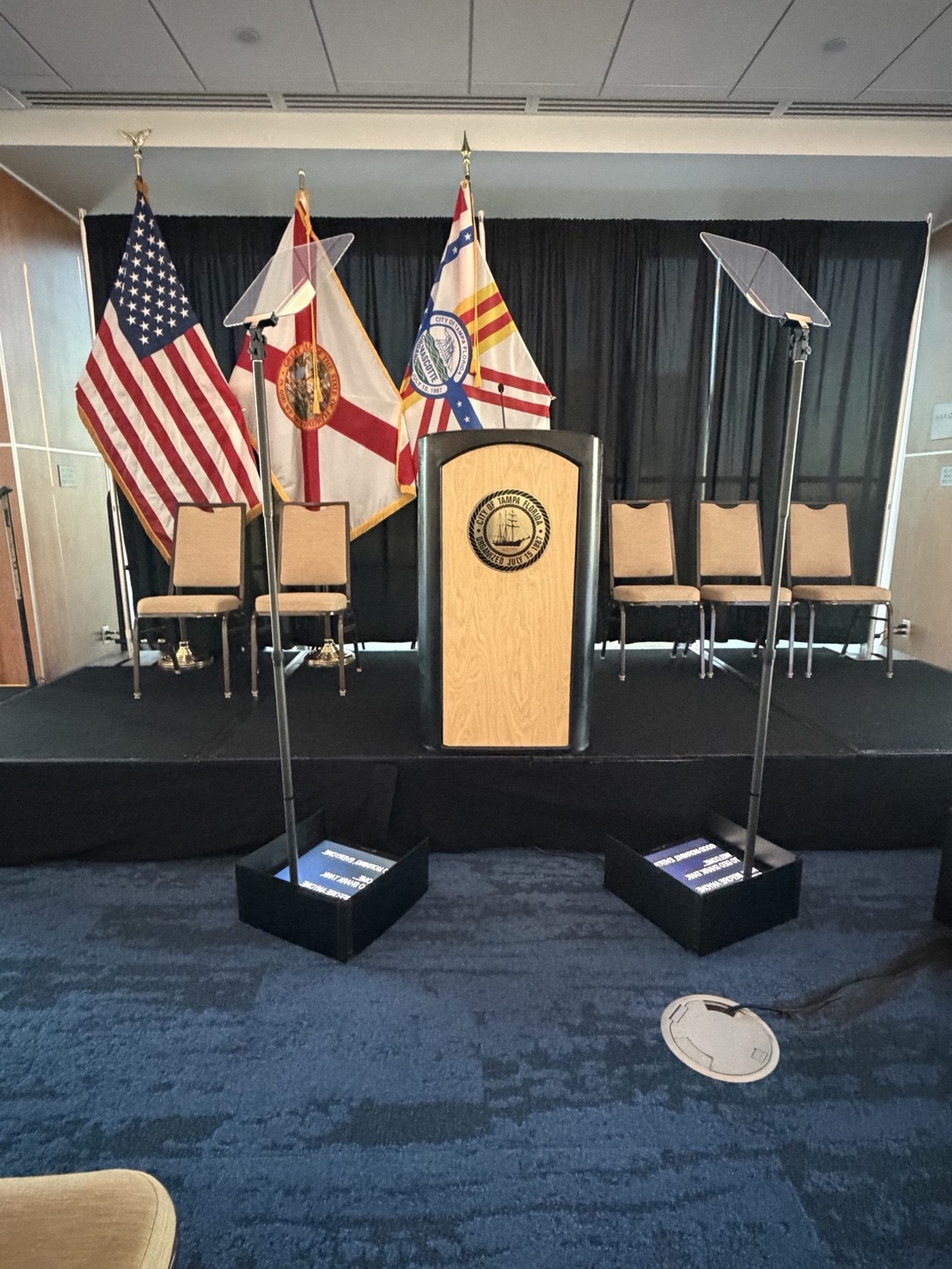 Presidential teleprompter at a flag-lined podium