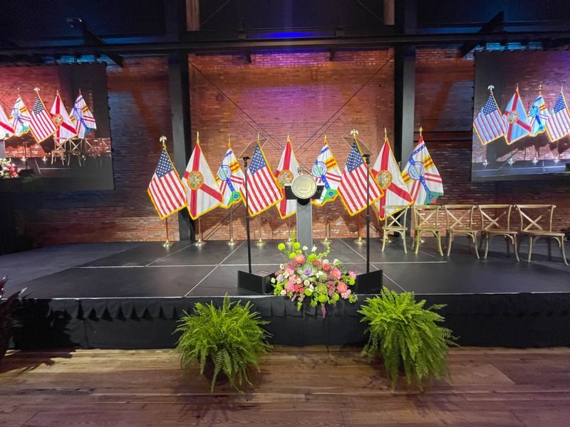 Presidential teleprompter glass on a flag-lined election stage